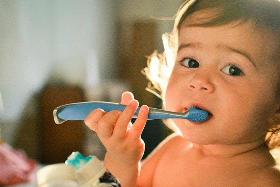 Bebê escovando os dentes sem usar creme dental