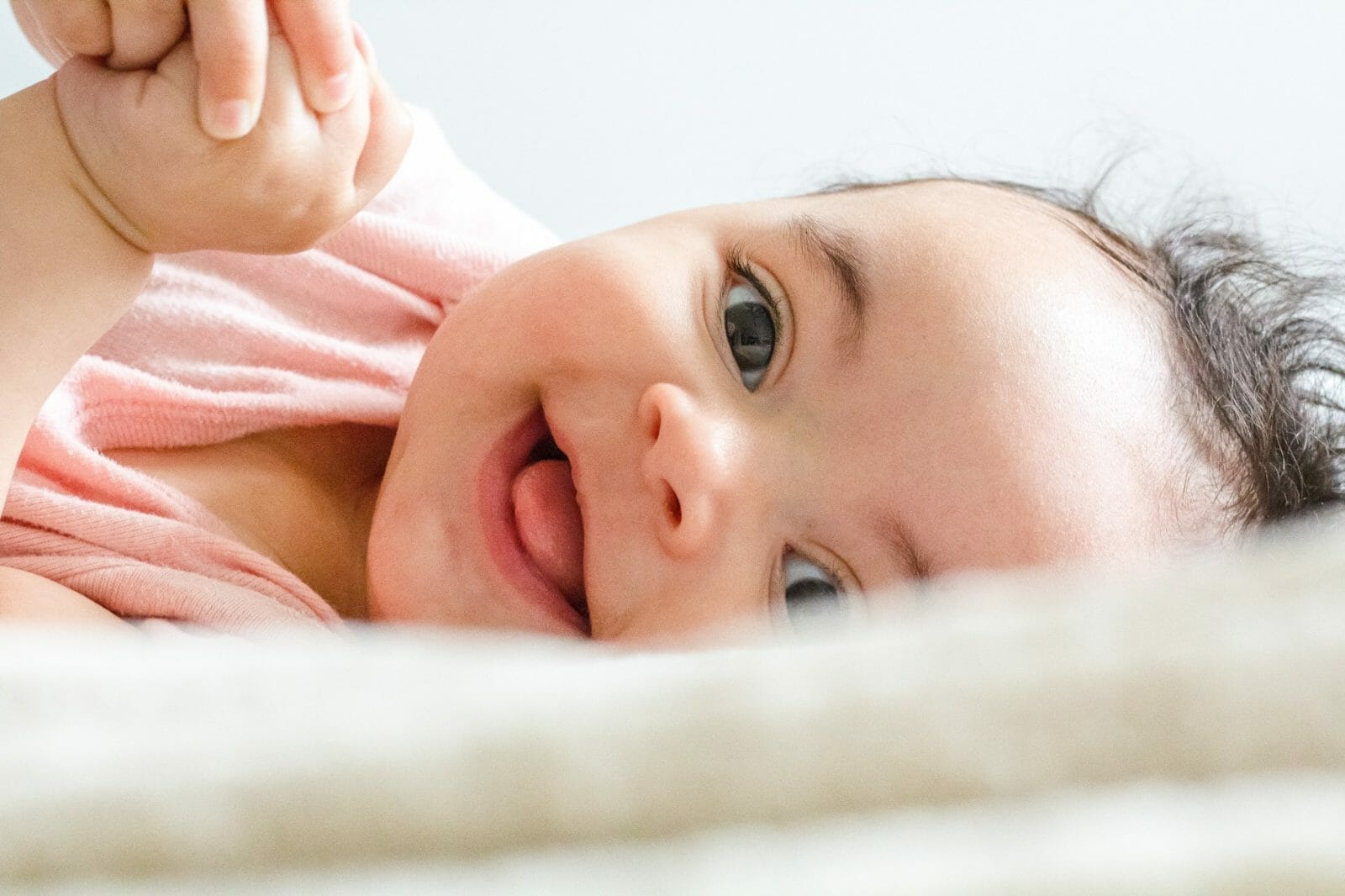 bebê sorrindo deitado na cama