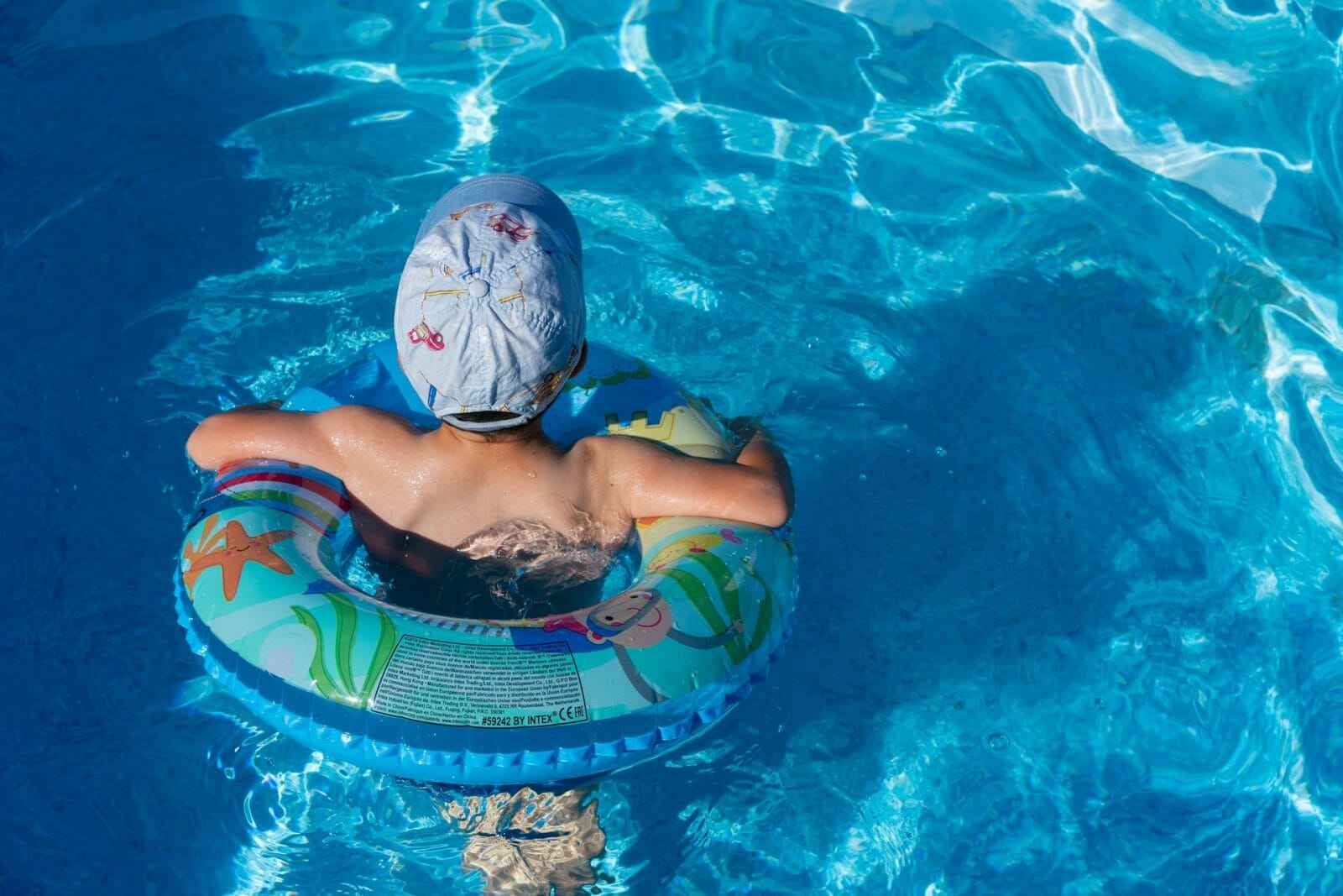 criança com uma boia na piscina