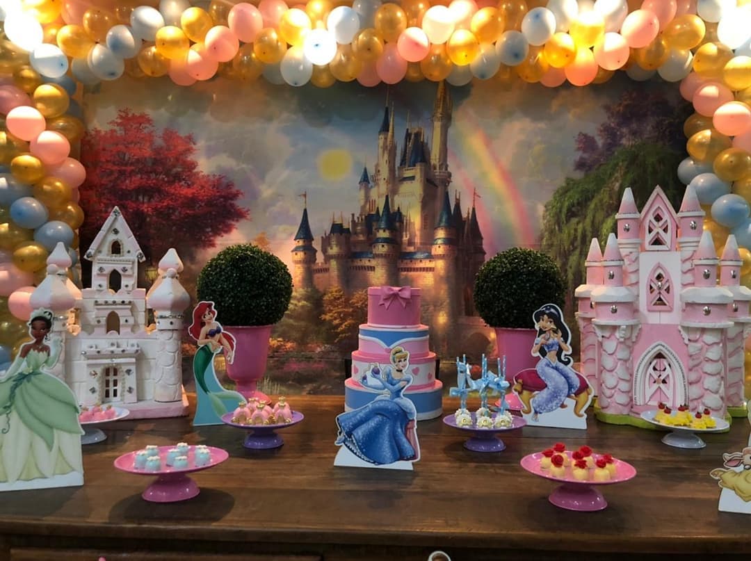 painel de festa infantil com tema de princesas, com destaque para castelos cor-de-rosa