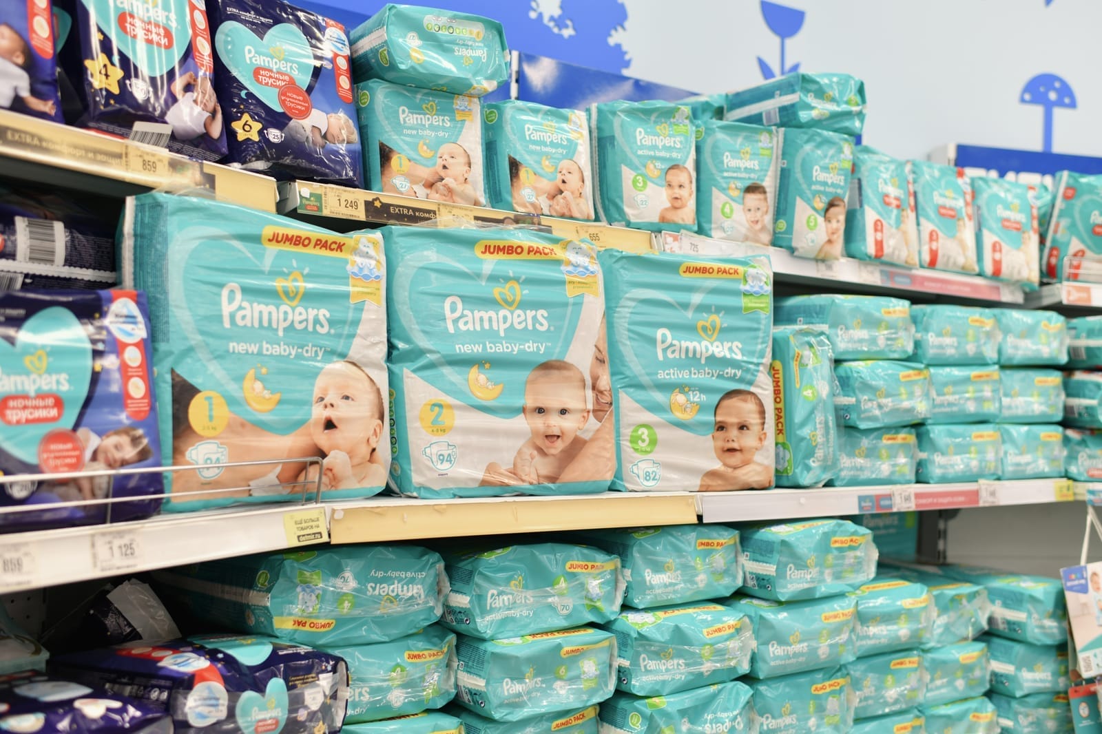 diversas fraldas pampers em prateleiras de um supermercado